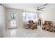 Inviting living room with bright white tile and lots of natural light at 1493 Kathleen Pl, Englewood, FL 34223