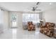 Inviting living room with bright white tile and lots of natural light at 1493 Kathleen Pl, Englewood, FL 34223