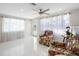 Bright living room with tile floors, cozy seating, and lots of natural light at 1493 Kathleen Pl, Englewood, FL 34223