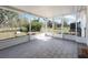 Bright screened porch with tiled floor, offering a pleasant view of the backyard at 1493 Kathleen Pl, Englewood, FL 34223