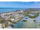 An aerial view of a waterfront community showcasing waterfront homes and a view of the Gulf of Mexico at 150 Crestview Dr, Englewood, FL 34223