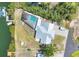 Aerial view of a waterfront home featuring a screened pool, private dock and boat lift at 150 Crestview Dr, Englewood, FL 34223