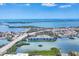 High-angle view showcasing a waterfront neighborhood with coastal views, serene waters, and a blue skyline at 150 Crestview Dr, Englewood, FL 34223