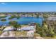 Stunning aerial view of waterfront home with lush landscaping and serene canal access at 150 Crestview Dr, Englewood, FL 34223