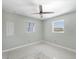 Neutral bedroom featuring a ceiling fan, two windows with bright light, and carpeted floors at 150 Crestview Dr, Englewood, FL 34223