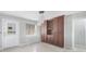 View of the dining room including a door, window, and wooden built in cabinets at 150 Crestview Dr, Englewood, FL 34223