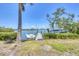 Scenic view of a private wooden dock featuring a boat lift on tranquil waters, perfect for boating enthusiasts at 150 Crestview Dr, Englewood, FL 34223