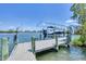 Close up of a boat lift at a private dock on the water with a boat safely secured at 150 Crestview Dr, Englewood, FL 34223