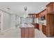 Bright kitchen area showcasing wood cabinets, marble countertops, modern appliances, and island at 150 Crestview Dr, Englewood, FL 34223