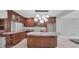 Well-lit kitchen with an island, custom cabinetry, granite countertops, and stainless steel microwave at 150 Crestview Dr, Englewood, FL 34223