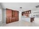 Spacious kitchen featuring custom wood cabinets, a built in wine rack, and a kitchen island at 150 Crestview Dr, Englewood, FL 34223