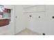 Bright laundry room featuring wire shelving and essential hookups, conveniently located near the kitchen at 150 Crestview Dr, Englewood, FL 34223