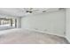 Open living room with large sliding doors leading to an outdoor area and concrete flooring, offering ample natural light at 150 Crestview Dr, Englewood, FL 34223