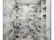 Modern shower featuring stylish stone tiles, built-in shelving, and a sleek design for a luxurious experience at 150 Crestview Dr, Englewood, FL 34223