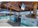 Outdoor tiki bar with under the sea decor, a built-in grill, and a TV, perfect for entertaining at 150 Crestview Dr, Englewood, FL 34223