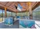 Outdoor tiki bar with under the sea decor, a built-in grill, and a TV, perfect for entertaining at 150 Crestview Dr, Englewood, FL 34223