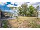 Expansive backyard features a covered patio, a shed, and mature trees, perfect for outdoor living and entertaining at 1530 Philip Pl, Englewood, FL 34223