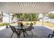 Relaxing covered patio with outdoor seating overlooking a large backyard, ideal for entertaining and enjoying the serene outdoors at 1530 Philip Pl, Englewood, FL 34223