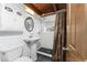 Updated bathroom with white subway tile, dark floors, modern fixtures, and wood accents at 1530 Philip Pl, Englewood, FL 34223