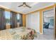Bedroom with yellow walls, white ceiling and floor tiles plus bed, closet, and open door to another room at 1530 Philip Pl, Englewood, FL 34223