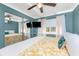 Inviting bedroom features a ceiling fan, windows, and sliding mirror closet doors at 1530 Philip Pl, Englewood, FL 34223