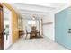 Bright dining room with wooden table, four chairs, and a blue entry door at 1530 Philip Pl, Englewood, FL 34223