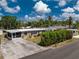 Single-story home featuring a screened-in porch, long driveway, and established landscaping at 1530 Philip Pl, Englewood, FL 34223