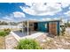 Backyard patio area of home with a covered seating area at 1530 Philip Pl, Englewood, FL 34223