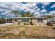 Exterior of the home showcasing the tidy landscape, newer windows and clean, neutral color palette at 1530 Philip Pl, Englewood, FL 34223