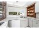Bright kitchen featuring quartz countertops, stainless steel sink, and white arabesque tile backsplash at 1530 Philip Pl, Englewood, FL 34223