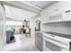 Open-concept kitchen with stainless appliances next to dining and living area with lots of natural light at 1530 Philip Pl, Englewood, FL 34223
