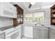 Well-lit kitchen with modern appliances and ample counter space with patterned backsplash at 1530 Philip Pl, Englewood, FL 34223