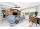 Cozy living room with two armchairs, rustic wood wall, and lots of natural light at 1530 Philip Pl, Englewood, FL 34223
