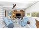 Comfortable seating area with two blue armchairs and a decorative wood-paneled wall at 1530 Philip Pl, Englewood, FL 34223