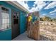 Unique outdoor shower area with charming decor, a privacy screen, and a convenient wash-off station at 1530 Philip Pl, Englewood, FL 34223