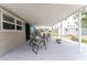 Charming covered patio with seating and a view of the well-maintained backyard at 1530 Philip Pl, Englewood, FL 34223
