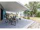 Outdoor seating area on a covered patio, ideal for enjoying the backyard view at 1530 Philip Pl, Englewood, FL 34223