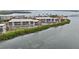 Waterfront condo complex with community pool and well-maintained landscaping, seen from the air at 1551 Beach Rd # 207, Englewood, FL 34223