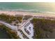 Aerial view of a beach with parking and lush surroundings at 1551 Beach Rd # 207, Englewood, FL 34223
