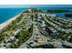 Aerial view of the waterfront community showcasing the beach, roads and local shops at 1551 Beach Rd # 207, Englewood, FL 34223