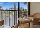 Enjoy a view from the balcony with outdoor furniture and a view of palm trees and a parking area at 1551 Beach Rd # 207, Englewood, FL 34223