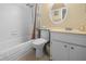 Bright bathroom featuring a shower and tub combination, white tile, and modern vanity at 1551 Beach Rd # 207, Englewood, FL 34223