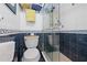 Updated bathroom features a walk-in shower, modern toilet and nautical accents at 1551 Beach Rd # 207, Englewood, FL 34223