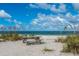 Scenic beach scene with a picnic table overlooking the water and beautiful clear skies at 1551 Beach Rd # 207, Englewood, FL 34223
