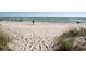 Sandy beach with dune grasses and the ocean in the background at 1551 Beach Rd # 207, Englewood, FL 34223