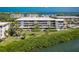 Waterfront condominium boasts multiple balconies with stunning views and beautifully maintained landscaping at 1551 Beach Rd # 207, Englewood, FL 34223