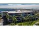 Waterfront condominium with multiple balconies overlooks manicured lawns and swaying palm trees at 1551 Beach Rd # 207, Englewood, FL 34223