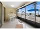 Relaxing lanai with white furniture, tile floor, and sliding doors showcasing water views and a blue patio umbrella at 1551 Beach Rd # 207, Englewood, FL 34223