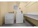 Community laundry room with washer, dryer, utility sink, and posted instructions at 1551 Beach Rd # 207, Englewood, FL 34223