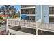 Spacious patio with outdoor seating under a blue umbrella, perfect for enjoying the beautiful view at 1551 Beach Rd # 207, Englewood, FL 34223